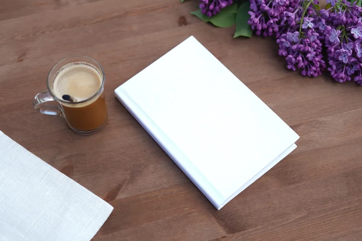 Livre à couverture neutre posé sur un bureau en bois, ambiance feutrée